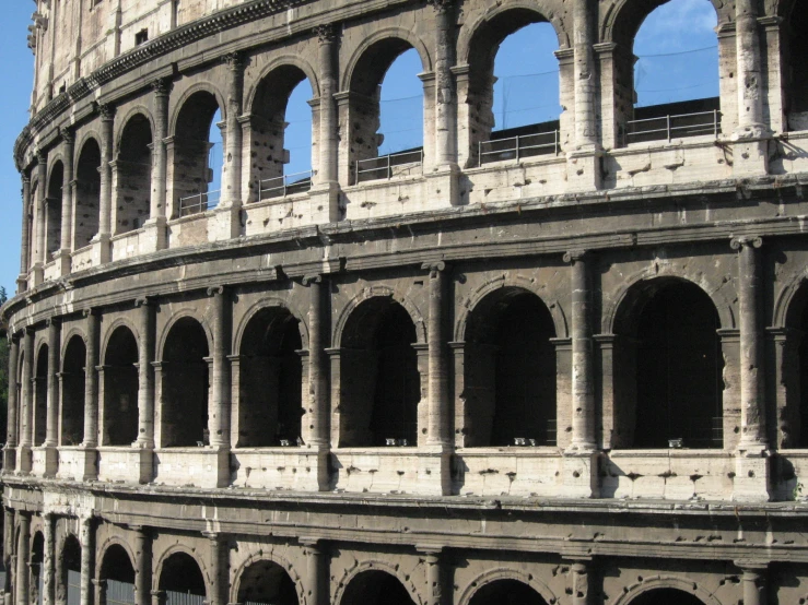 the large arena with stone arches and arched windows