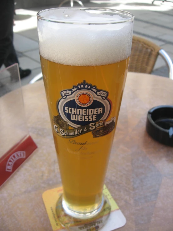 a glass of beer on top of a table