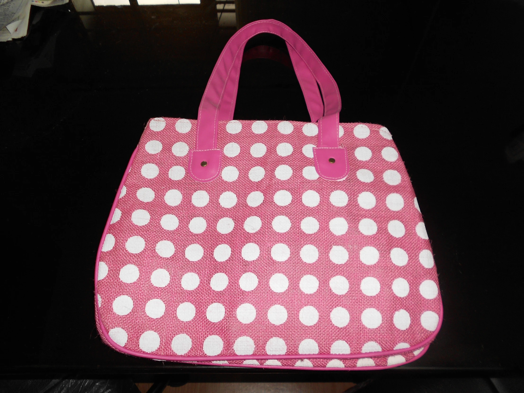a bag with white polka dots sitting on a table