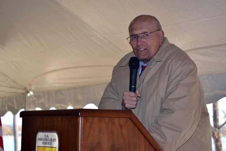 a man speaking into a microphone at a podium