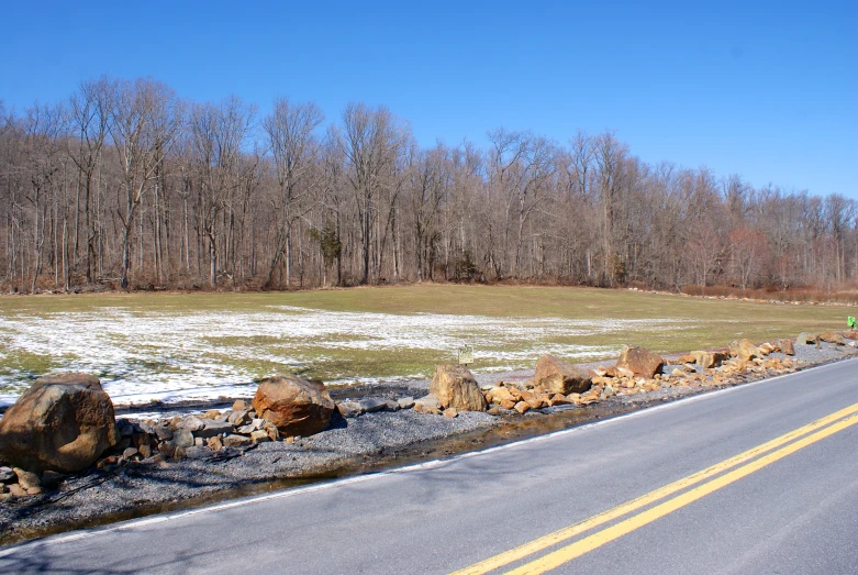 a long road leads to a snow covered field