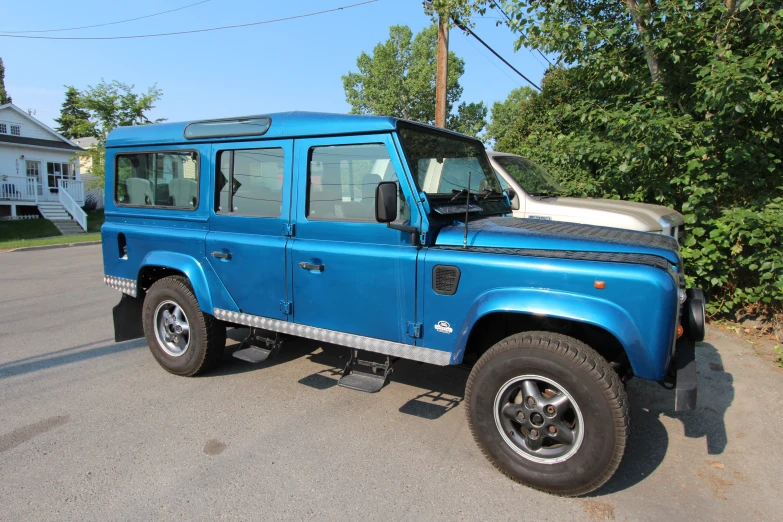 a blue suv that is parked on the street