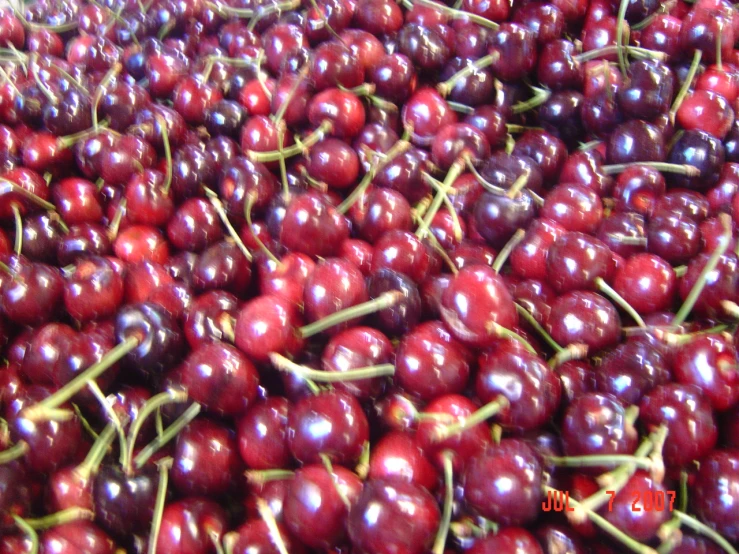 many cherries are piled on top of each other