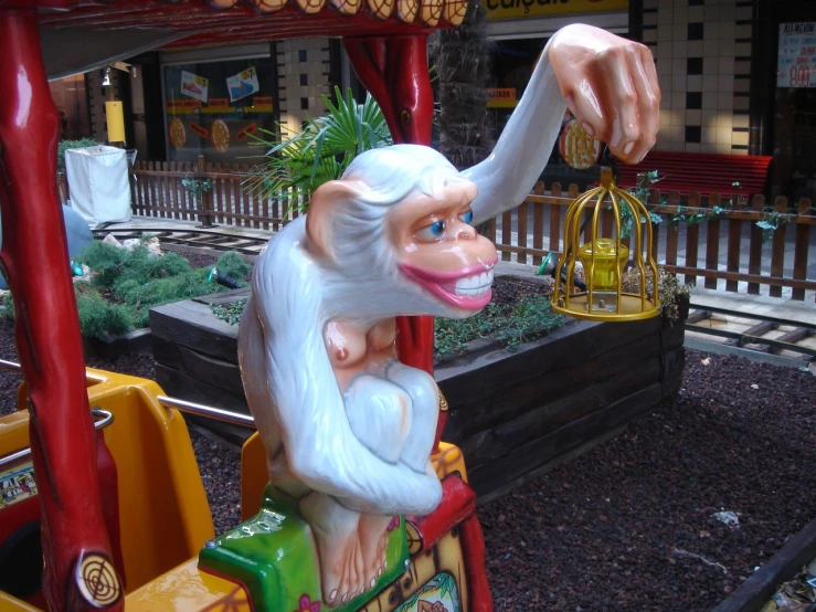 a sculpture of a monkey with a cage on his back