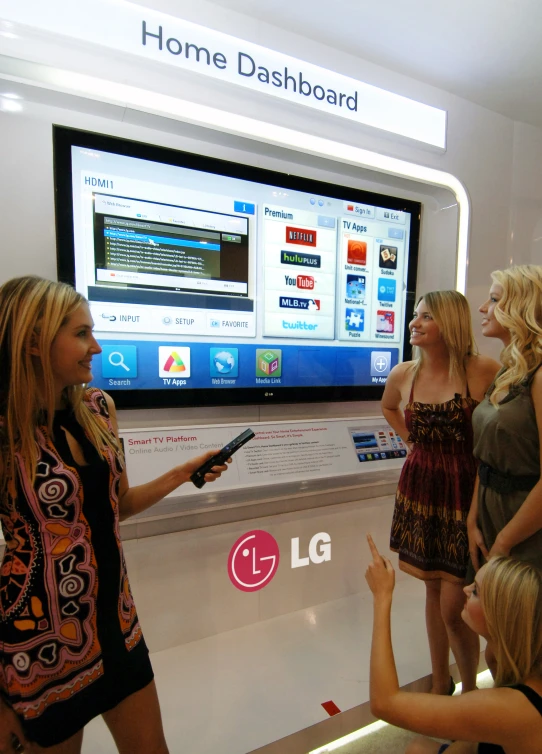 the young ladies are discussing what is on the large television