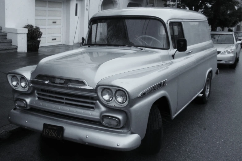 the classic chevrolet van is silver in color