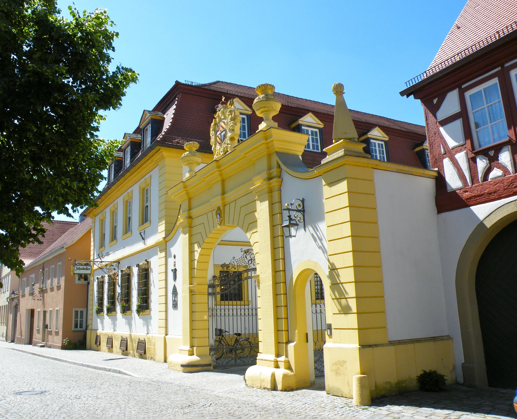 a large yellow building has a golden lion on it