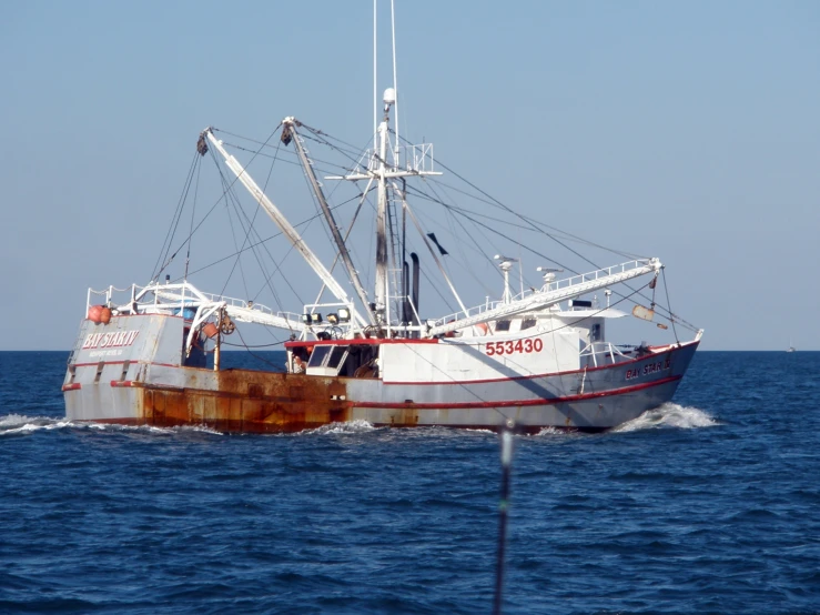 two boats sailing in the blue water together