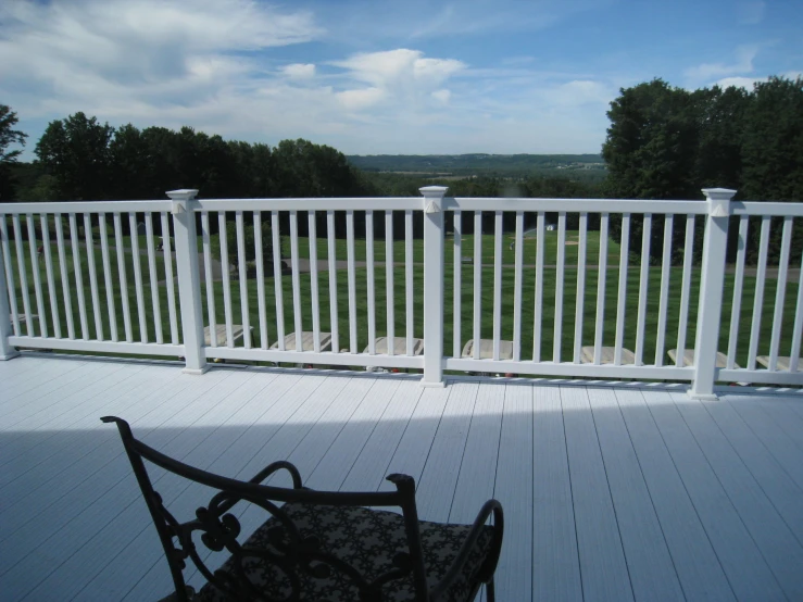 a balcony overlooking an open grassy field