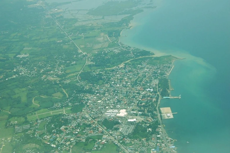 a view from above of a small town, sea and island area