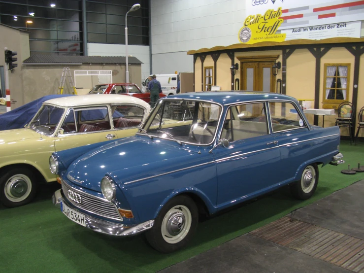 old classic cars on display in building at show