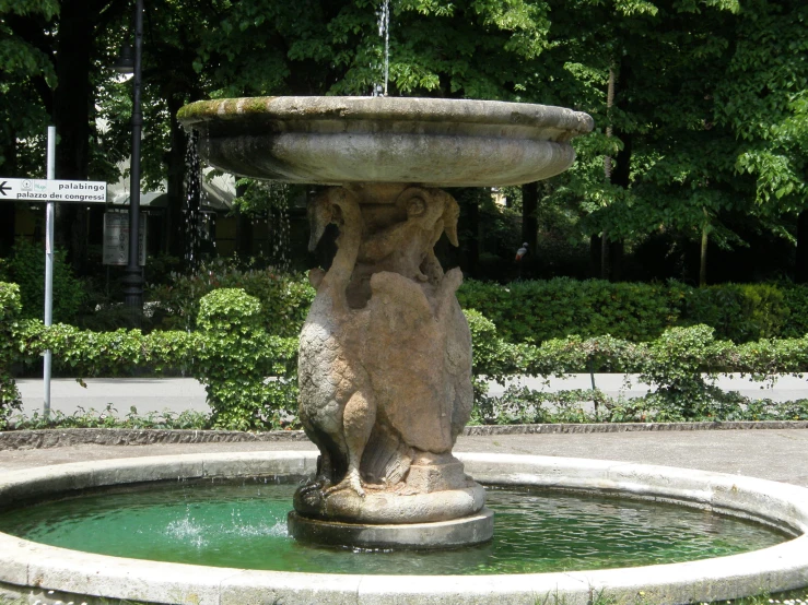 a fountain has a statued animal on it