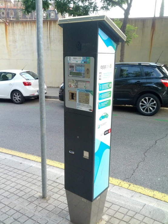a parking meter on a side walk in the street
