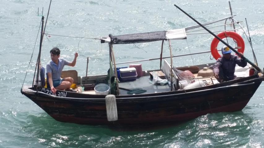 two men in a boat with a life saver around them