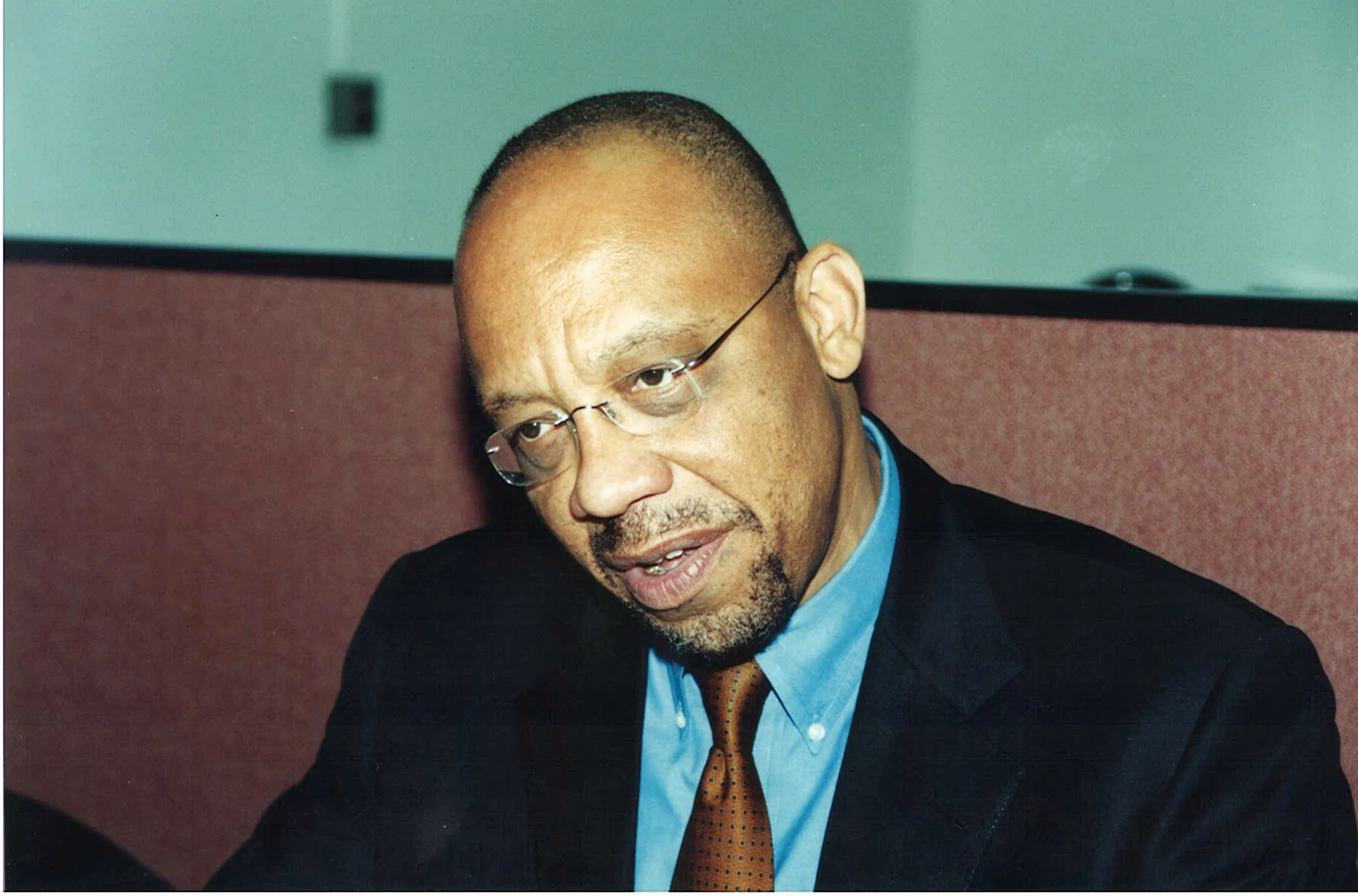 a man in glasses sitting at a desk