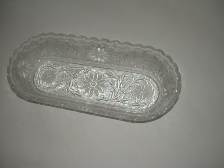 a clear plate with ornate design in it