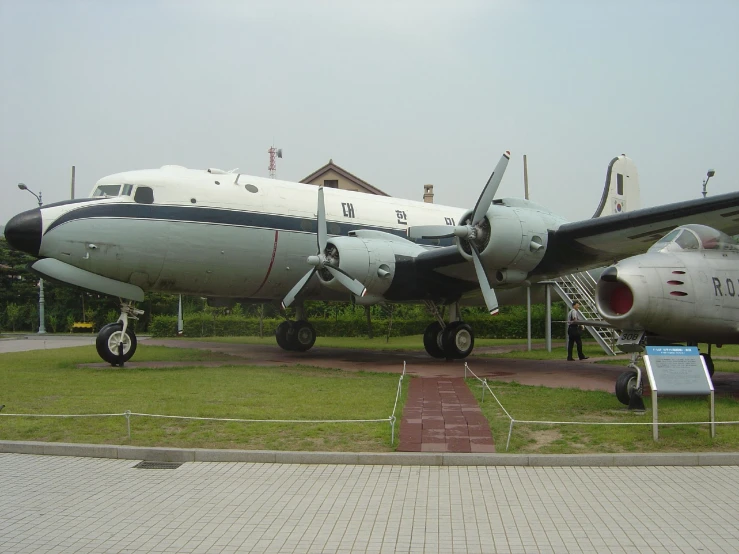 a large jet plane sitting on top of a grass field