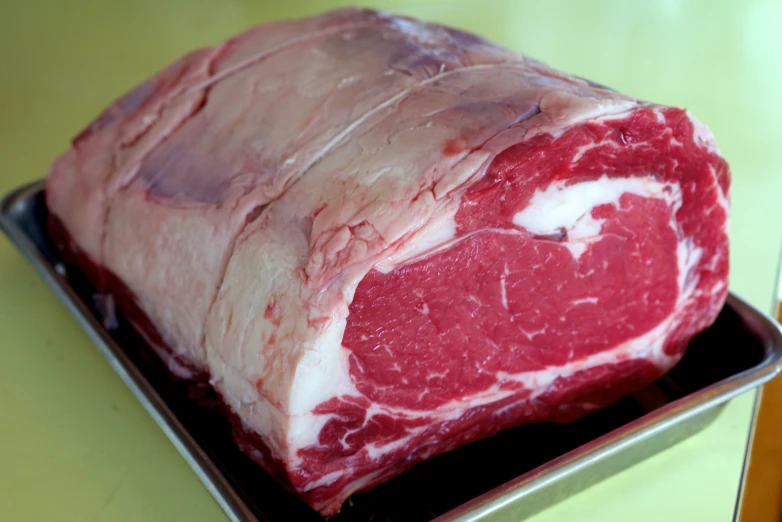 a large portion of meat sitting in a metal pan