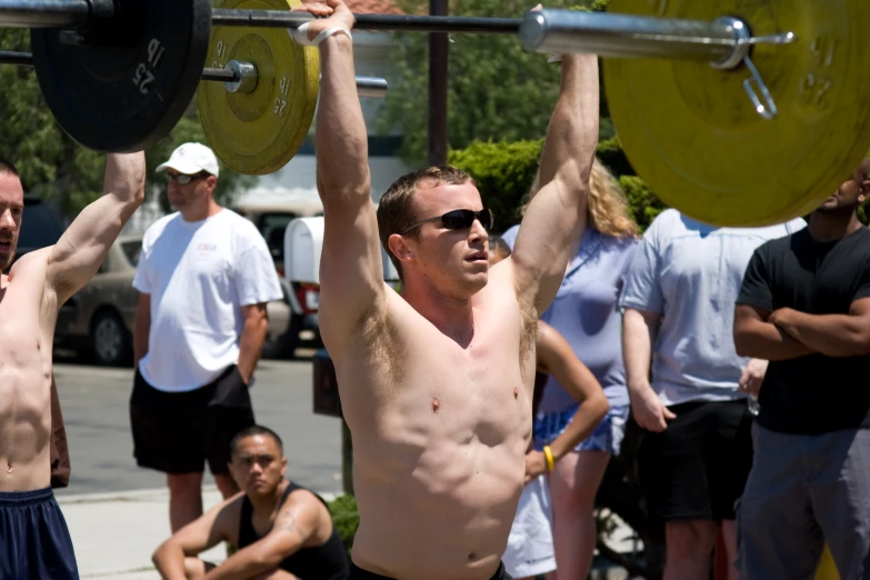 some guys that are lifting some kind of barbell