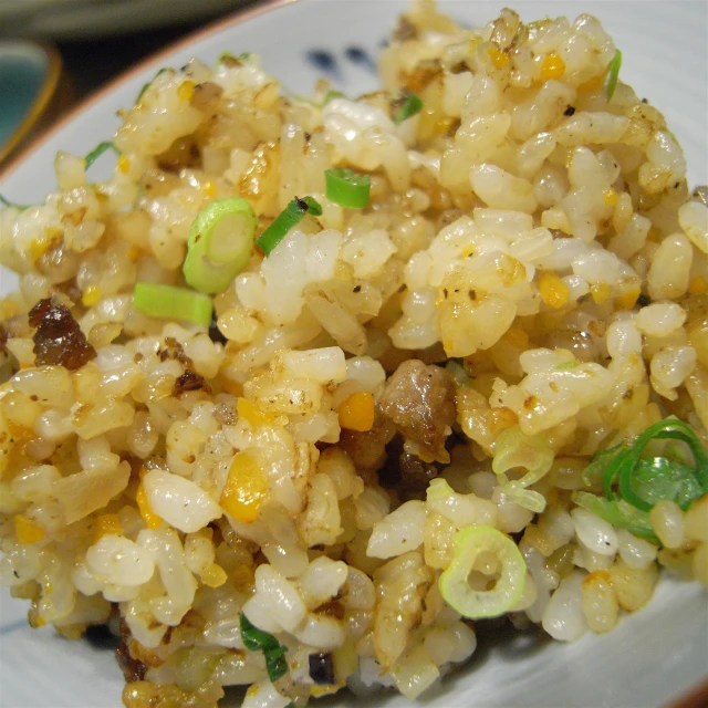 a plate full of rice, topped with various vegetables