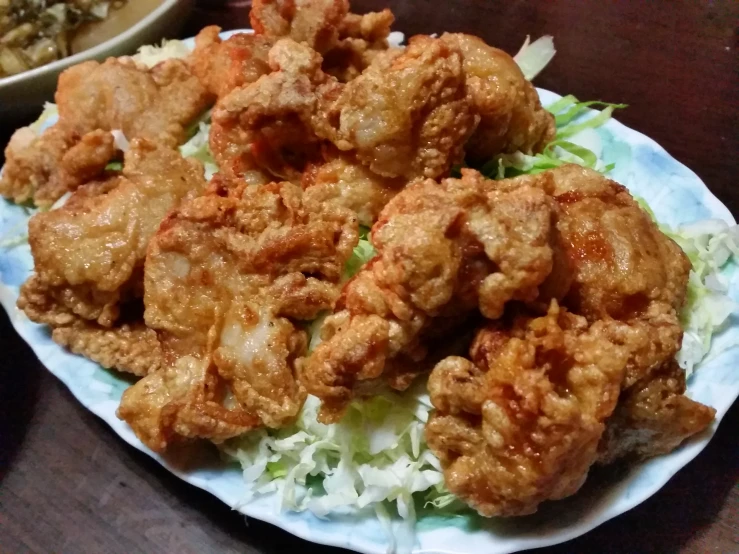 a plate with fried food and lettuce on it