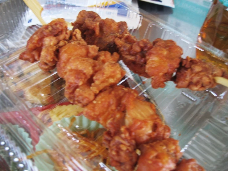 a close up of some chicken in a plastic container