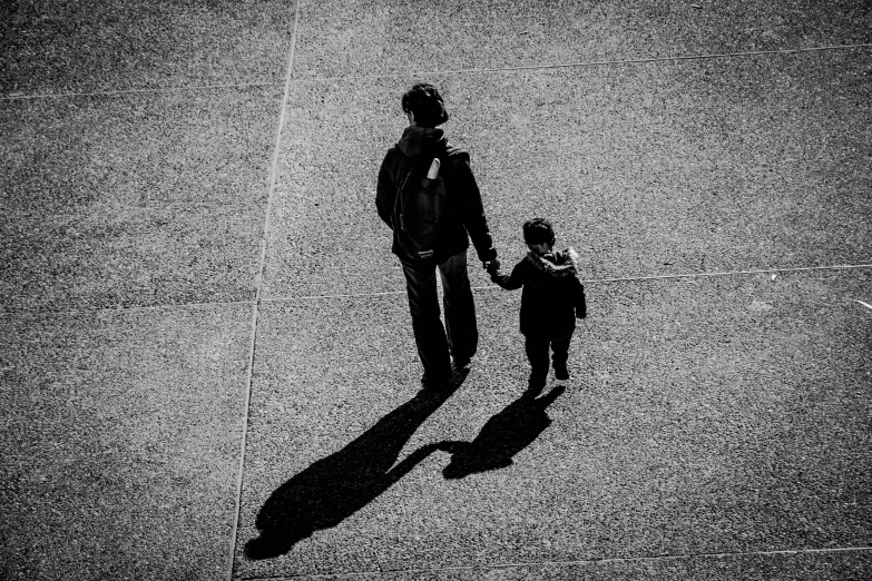 a man and a young child are shown holding hands