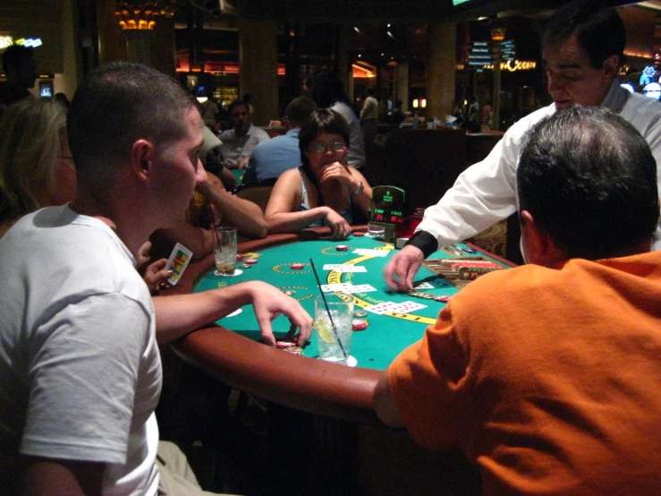 two guys playing a card game at a casino