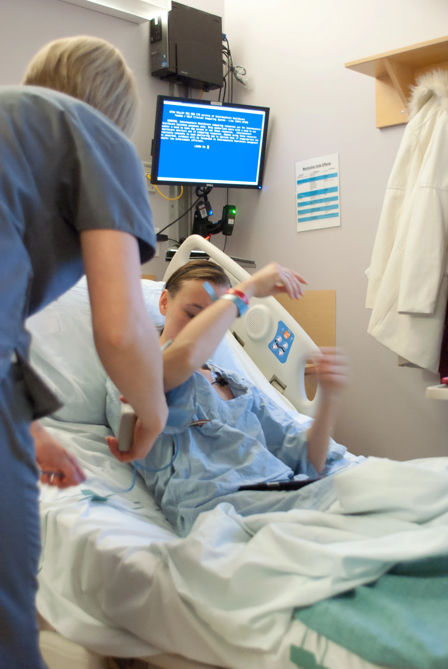 two people are in the hospital one person is holding an object