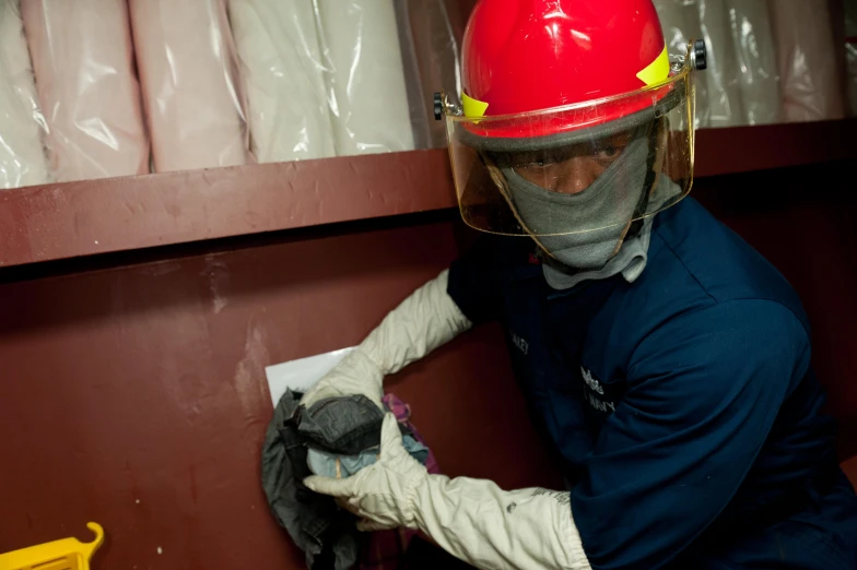 a man in uniform is putting on his gloves