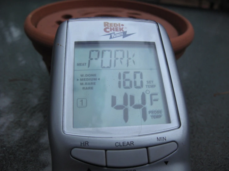 a close up of an electronic device with a weather vane