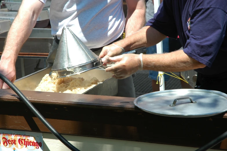 a person who is grating some food out of a tray