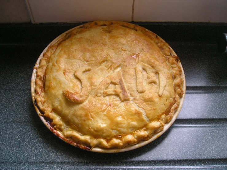 a pie sitting on top of a black counter top