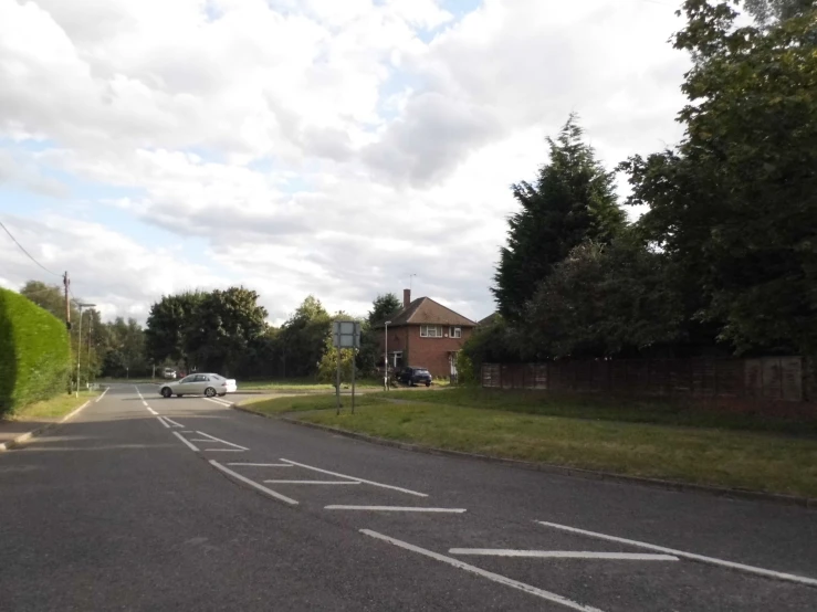 an intersection with a white car in the middle of it