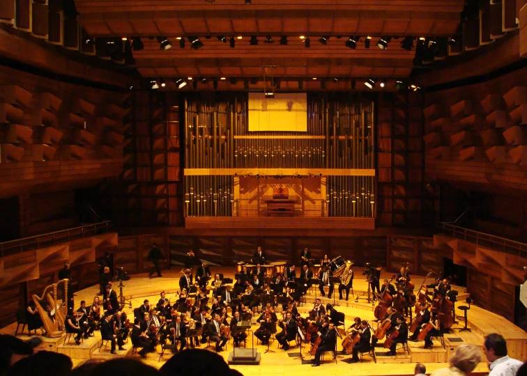 orchestra playing in a big wooden building