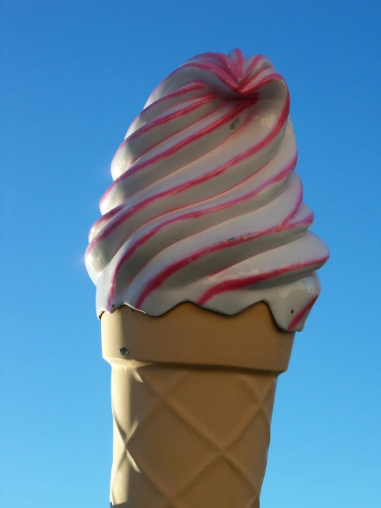 a giant cone of ice cream with red and white stripes