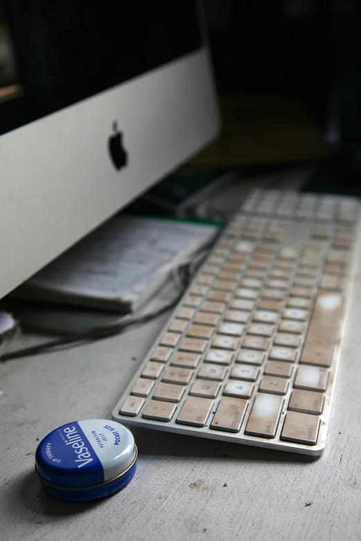 a white keyboard and some papers and a mouse