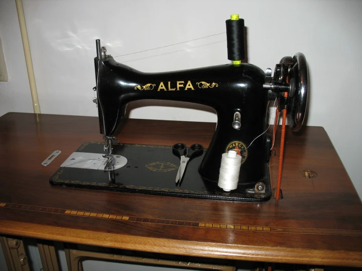 an antique sewing machine is sitting on a desk