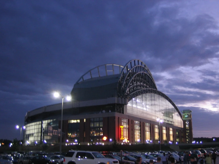 stadium building with car parking lot at night