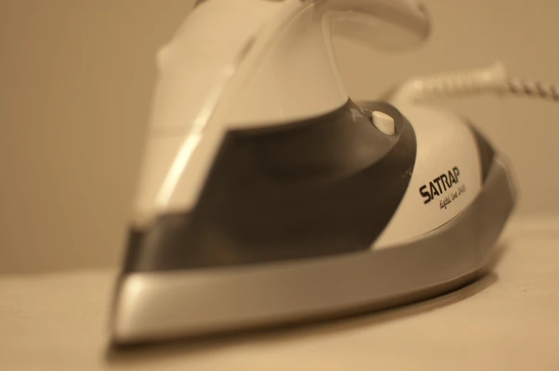 a white and grey iron sitting on top of a table