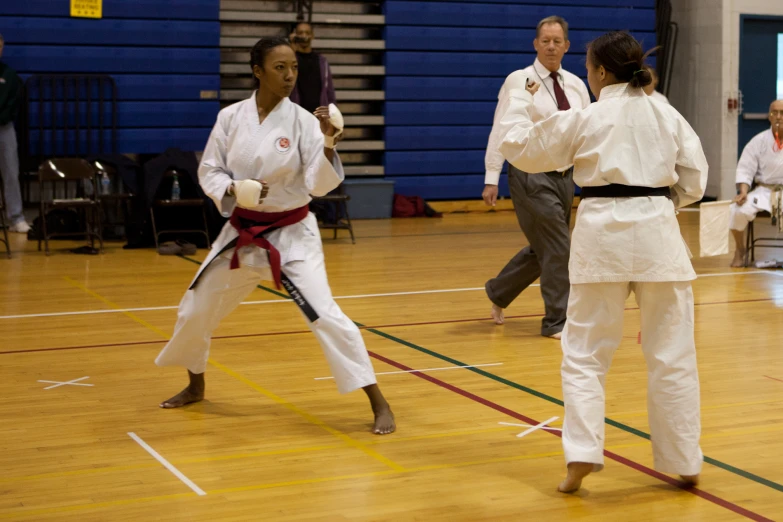two people on a court while wearing karate gear