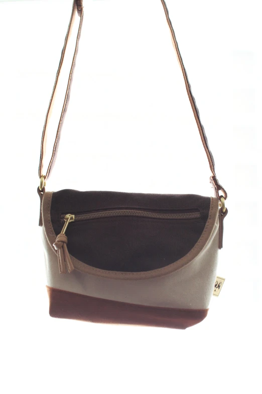 a cross body bag with a zipper and strap