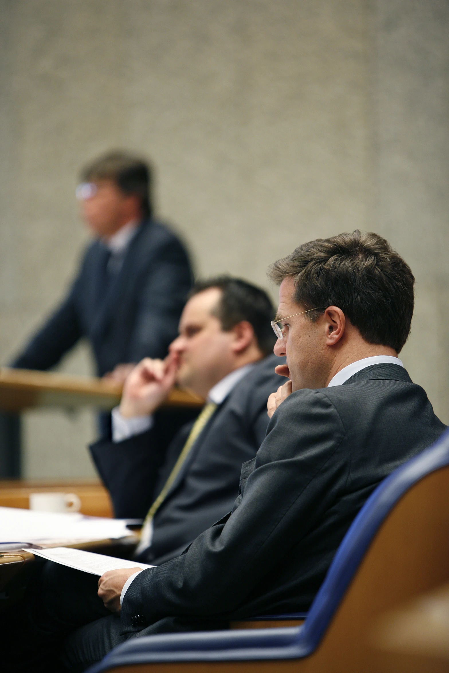 two business men sitting at the front of a table