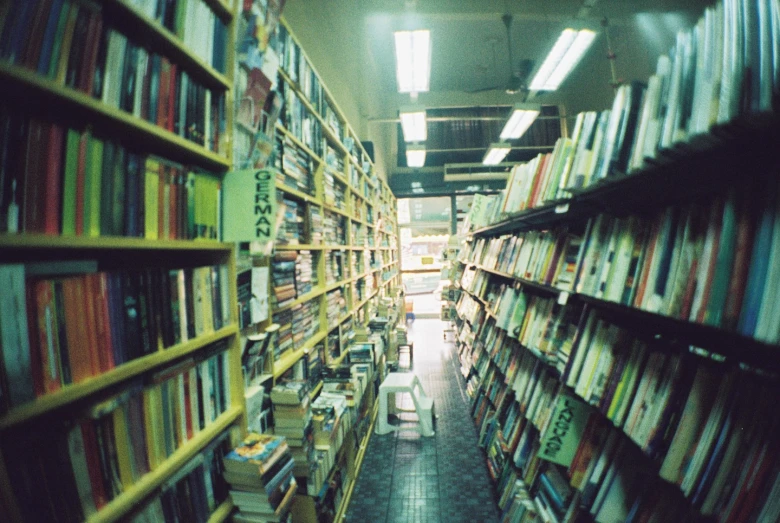 the aisle of a bookshop with dozens of books on shelves