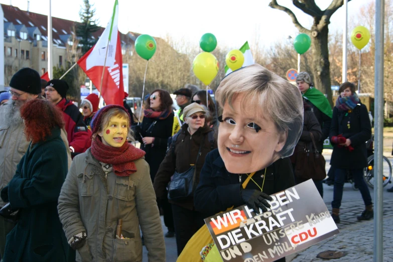 people with a political figure of a politician holding up signs