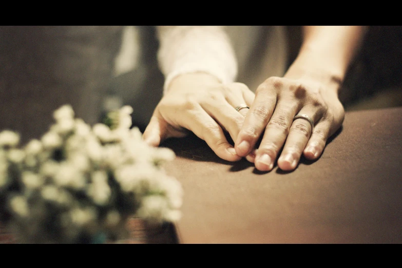 closeup of two hands holding each other's fingers