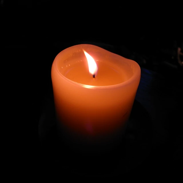 a lit candle is sitting on a table