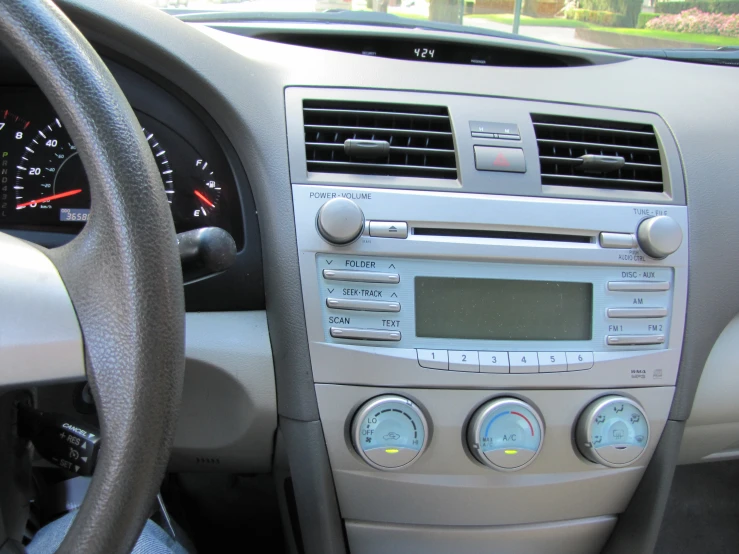 the dashboard of a car has many controls and is very small