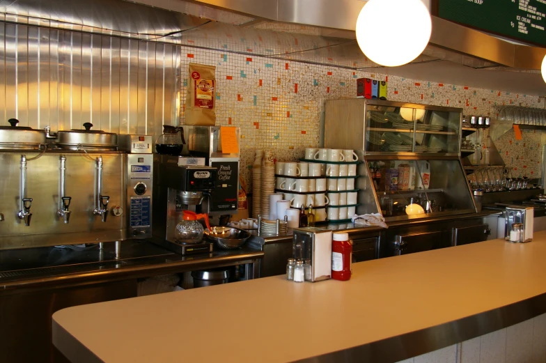 a coffee shop with stainless steel equipment and lights