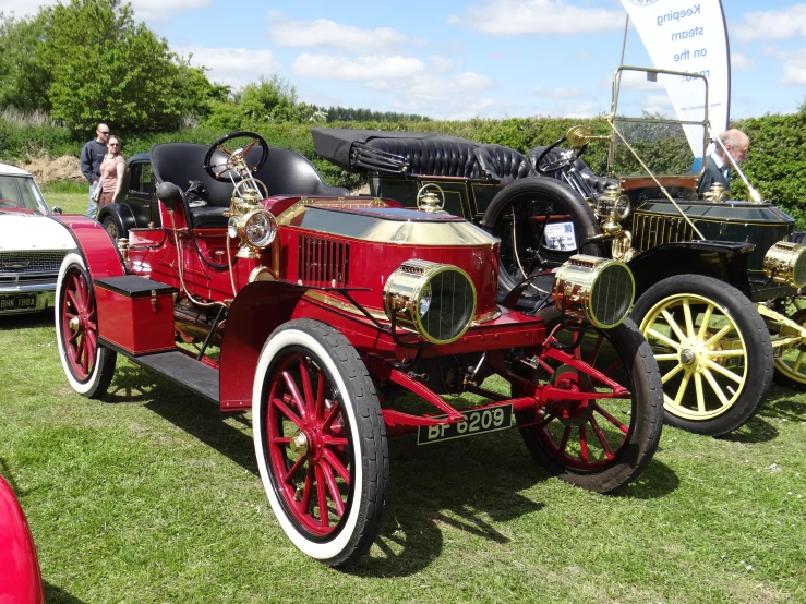 the classic cars on display are parked in the grass